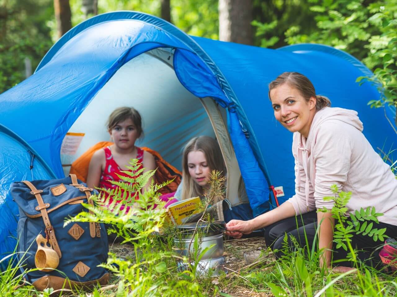 Äiti ja lapset telttailemassa.